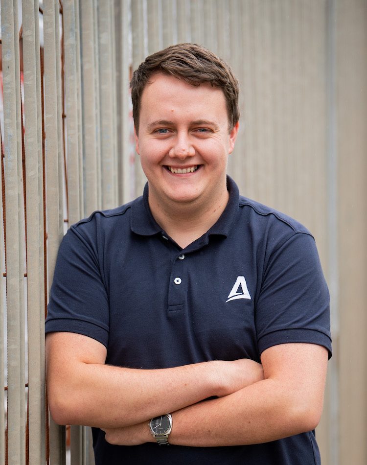 Aquarius IT Member Smiling With Arms Folded